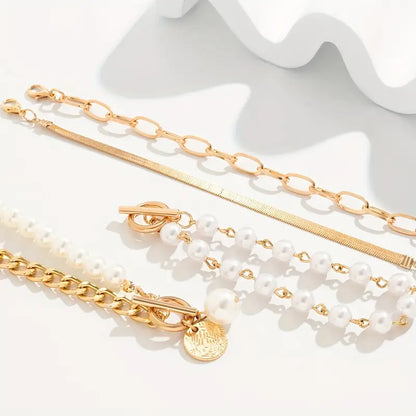 Elegante set de pulseras doradas (4 piezas) – serpiente, perlas y eslabones